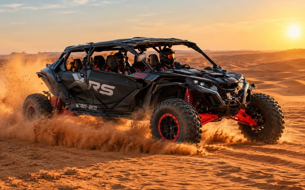 Can-Am Maverick R 4 seats racing across the Dubai dunes at sunset